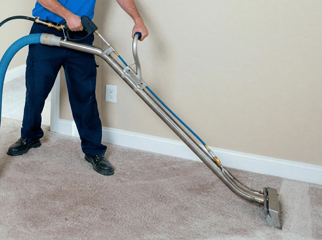 Professional operating a liquid removal machine on a carpeted floor in Evansville, IN